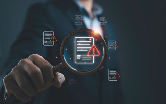 Error detection and document verification concept with magnifying glass highlighting warning alerts on digital files. Symbol of risk analysis, troubleshooting, compliance check and quality control.