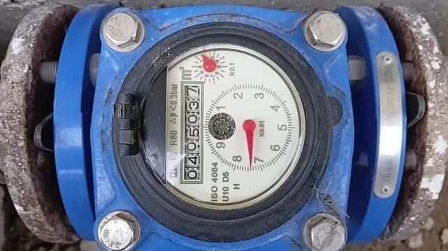 Close Up Of An Industrial Bulk Water Meter Dial Operating And Measuring Water Flow In A Horizontal Position