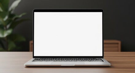 Fototapeta premium Modern silver laptop computer with blank white screen on a wooden table showcasing technology and productivity