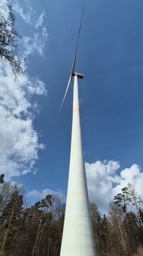 Wind turbine against blue sky.