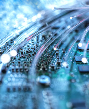 Glowing fiber optic cable on computer circuit board