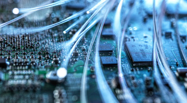 Glowing fiber optic wire on a circuit board for AI data