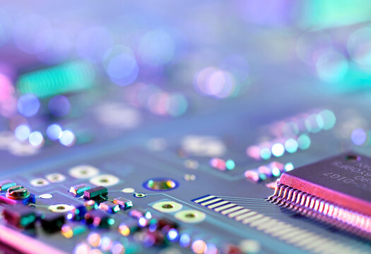 Close up of a glowing electronic circuit board and microchip
