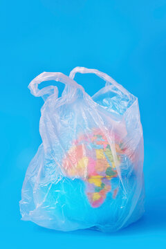 Globe inside a clear plastic bag against a blue background