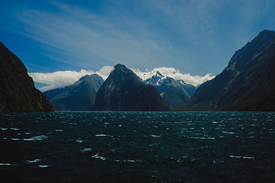 Dramatic view of Milford Sound with dark water and rugged mountains