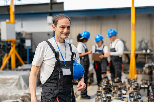 Factory supervisor smiling in a manufacturing plant