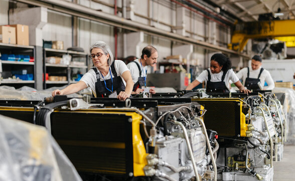 Engineers working on an assembly line in a factory