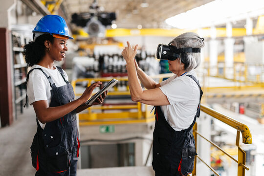 Teamwork with virtual technology and tablet in machinery factory