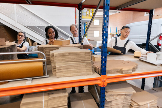 Workers preparing cardboard boxes in a warehouse