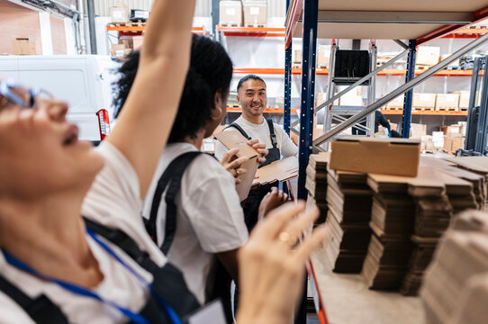 Workers packaging boxes for shipping in a warehouse