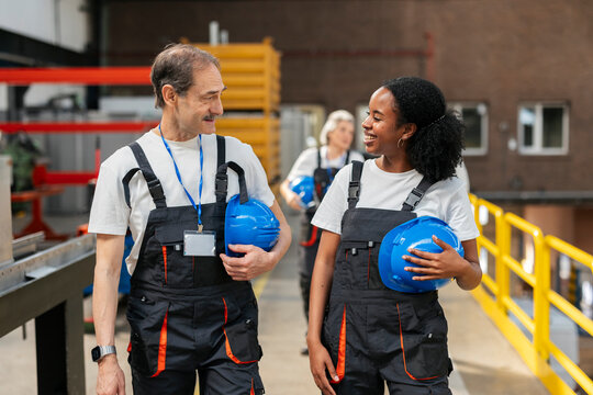 Worker and supervisor walk and communicate in a manufacturing plant