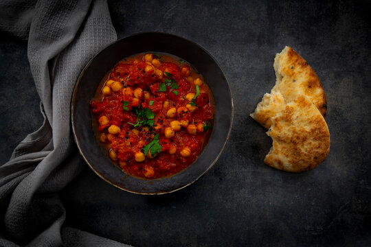 Indian chana masala chickpea curry and naan bread from above