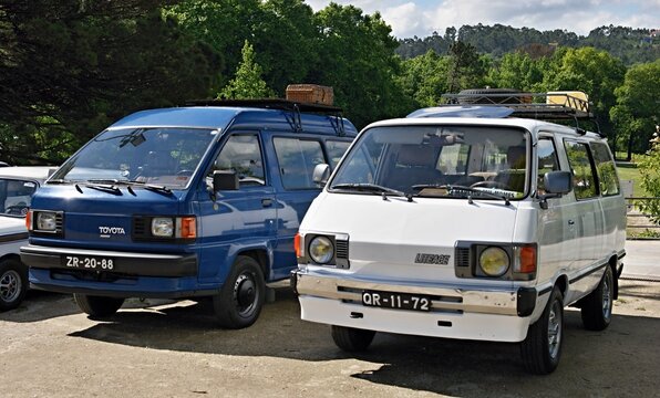 Toyota LiteAce vans parked with roof racks for travel