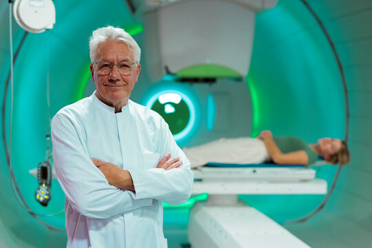 Doctor in a radiology treatment room with a patient undergoing proton therapy