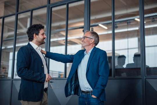 Engineers communicating and supporting each other in an office setting