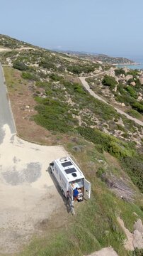 Explore the stunning landscapes of Chalkidiki, Greece, as a camper van parks overlooking the serene coastline. Enjoy tranquil moments, blue waters, and the essence of travel in this beautiful region.