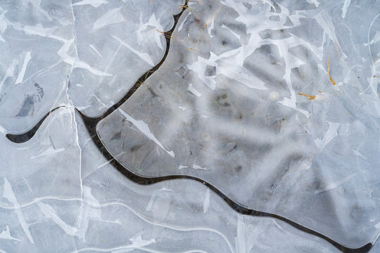 Abstract texture of a cracked ice surface in winter