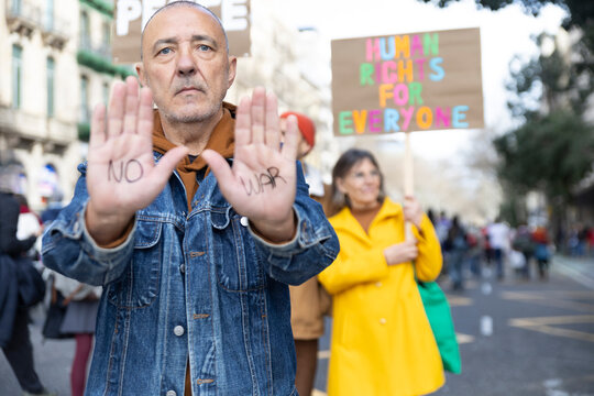 Demonstrator showing no war message on hand at city protest