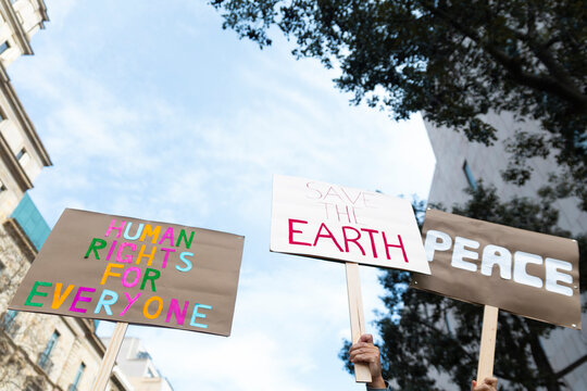 Hands holding protest placards for peace and solidarity in Barcelona