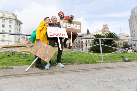 Family taking a selfie while protesting for peace
