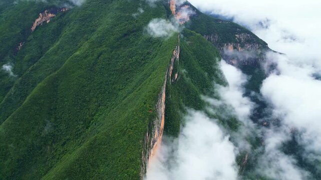 Misty Green Mountain Cliffs Above Forested Valley