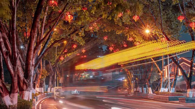 Festive Night Street with Red Lanterns and Traffic Under Trees