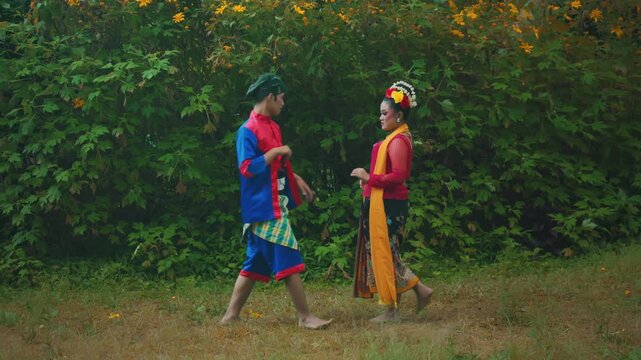 Traditional Indonesian Dancer Couple Performing a Romantic Scene Outdoors