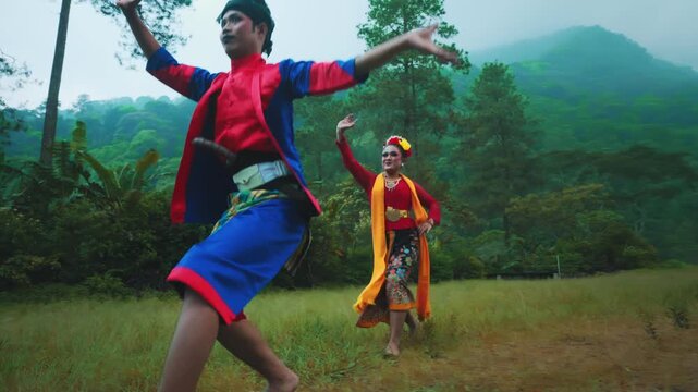 Male Indonesian Dancer with Powerful Leap and Female Dancer's Graceful Stance