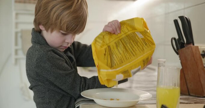 Kid Boy Eats Corn Flakes Meal in Kitchen. 4K 10-bit