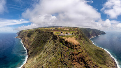 Aerial drone view of the Madeira coastline with steep cliffs, Atlantic Ocean, and natural landscape. Calm travel scene with typical Portuguese island scenery. © coffeinlix 