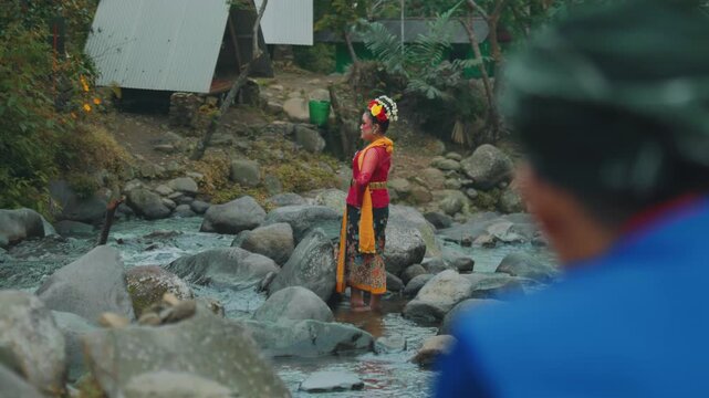 Female Traditional Dancer Posing on River Stones in Nature