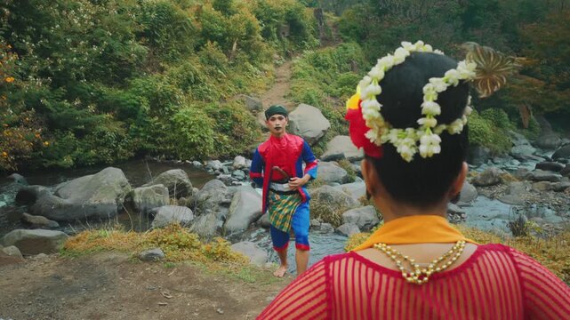 Male Javanese Dancer Crossing River Towards Partner