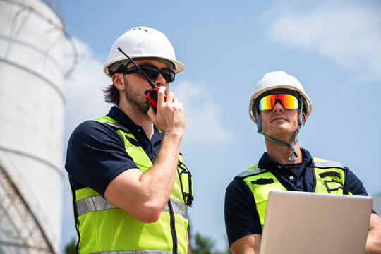 Refinery Engineer Using Walkie Talkie During Petroleum Infrastructure Inspection At Petrochemical Energy Facility