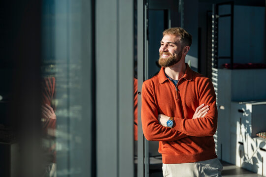 Young man smiling in a modern office setting