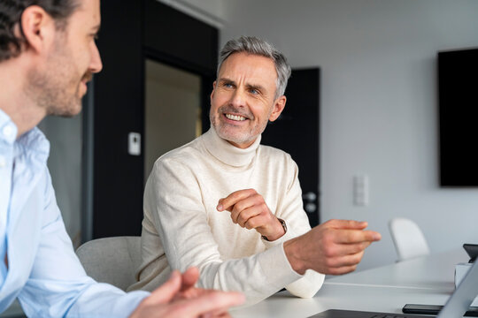 Two men having a business discussion in an office setting