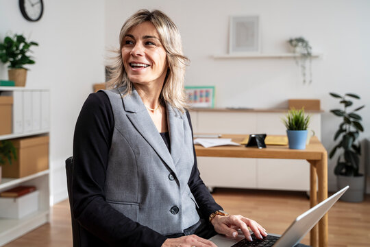 Businesswoman working on a laptop in a modern office