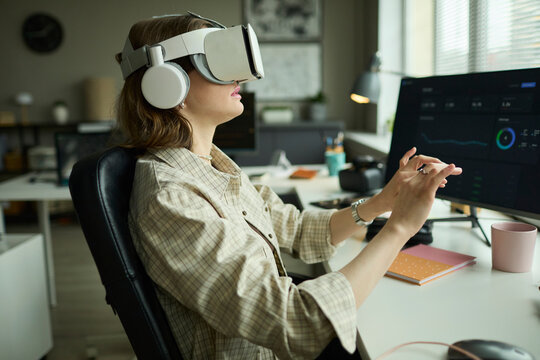 Developer using AR goggles for virtual work at the office