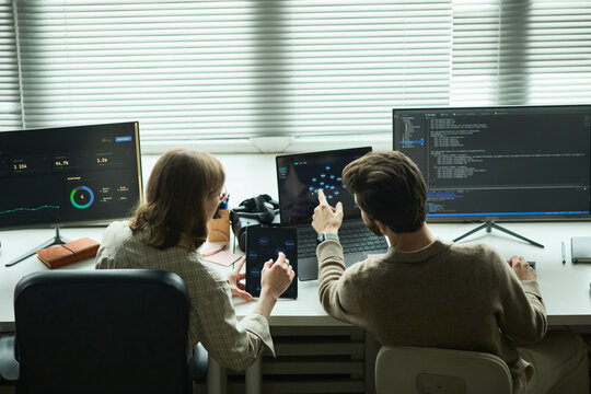 Developer and manager analyzing code at the office