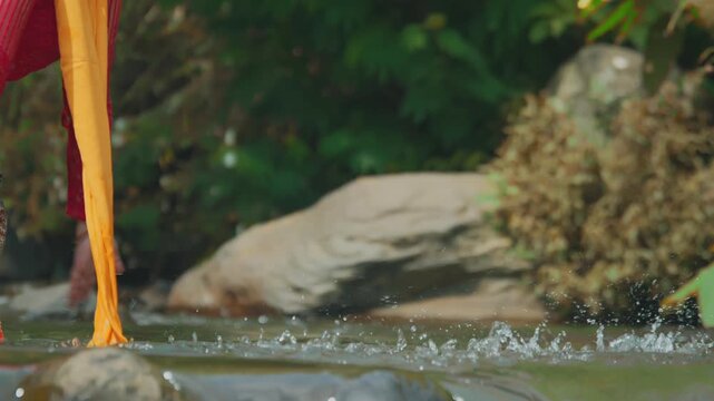 Close-Up of Traditional Dancer Hands Splashing River Water