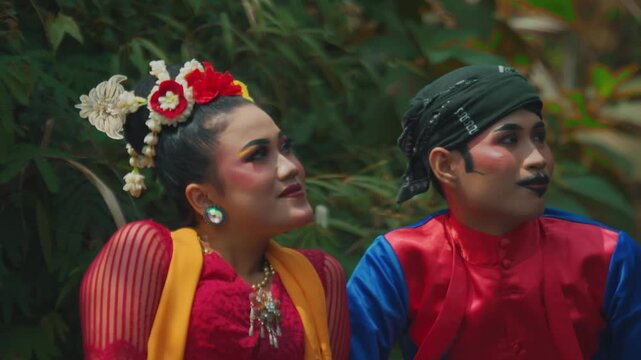 Traditional Dancers Gazing Upwards in Forest Setting