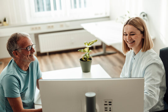 Doctor and patient smile during hospital consultation