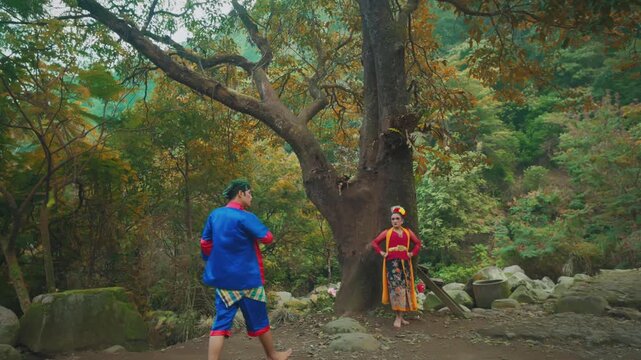 Folk Dance Performance Under Large Tree with Autumn Leaves