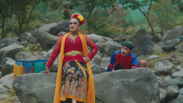 Javanese Folk Dancer Posing While Partner Hides