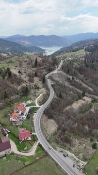 Izvorul Muntelui aerial view with winding road and Bicaz Lake