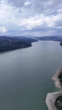 Bicaz Lake wide aerial panorama with forested mountain shores
