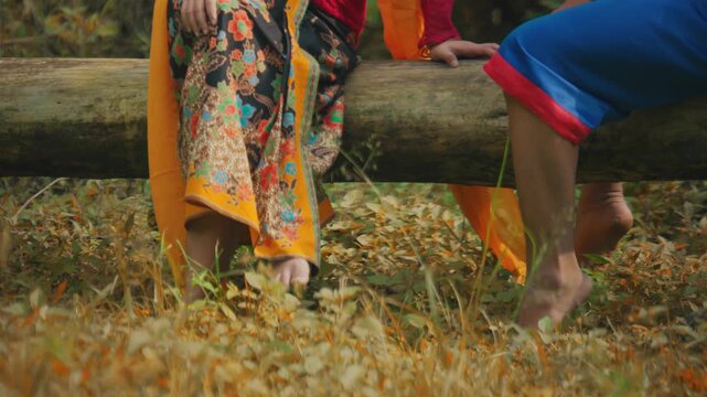 Low Angle of Couple's Feet Swinging Playfully on Log