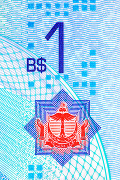 national crest and the face value number 1 on a Brunei 1 Dollar banknote. textures on polymer currency from Negara Brunei Darussalam
