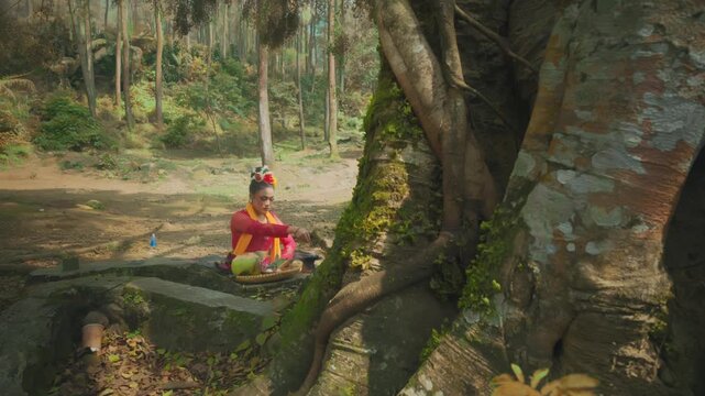 Traditional Woman Performing Ritual by Sacred Tree Roots