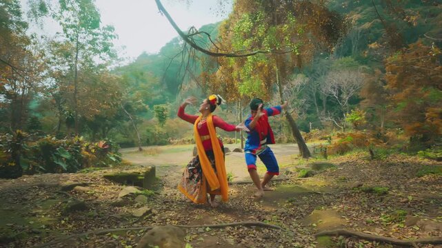 Traditional Dancer Couple Performing in Lush Forest Setting