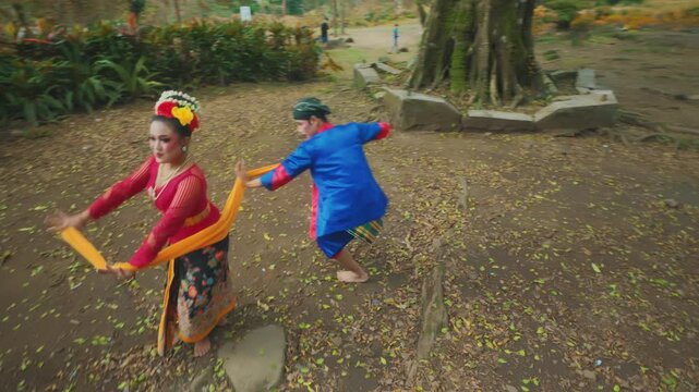 Playful Sash Dance by Traditional Indonesian Couple